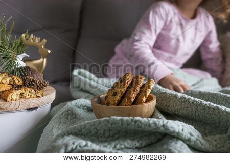 The Girl Has A Delicious Chocolate Biscuit Breakfast. The Child Is Sitting On Dwan. Home Comfort And