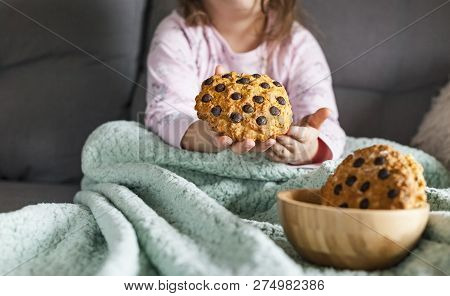 The Girl Has A Delicious Chocolate Biscuit Breakfast. The Child Is Sitting On Dwan. Home Comfort And