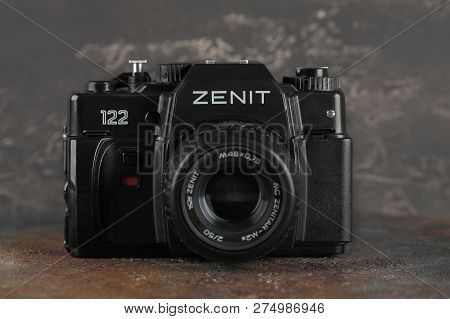MOSCOW, RUSSIA, DECEMBER 21, 2018. The old Soviet 35 mm SLR camera Zenit 122, released 2001, on gray-brown cement background.
