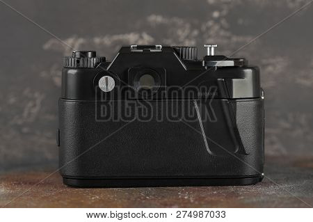 MOSCOW, RUSSIA, DECEMBER 21, 2018. The old Soviet 35 mm SLR camera Zenit 122, released 2001, on gray-brown cement background.