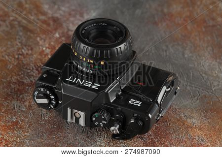 MOSCOW, RUSSIA, DECEMBER 21, 2018. The old Soviet 35 mm SLR camera Zenit 122, released 2001, on gray-brown cement background.