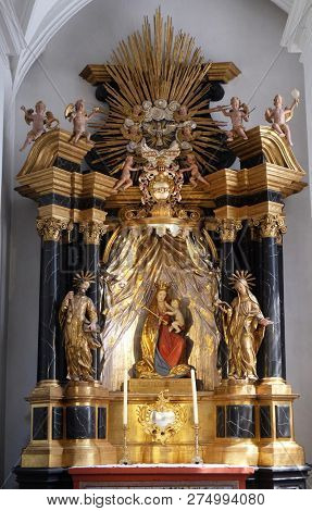 WURZBURG, GERMANY - JULY O4, 2018: Madonna with child Jesus, altar in the Neumunster Collegiate Church in Wurzburg, Germany
