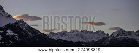 Panoramic View Of A Mountain Range With Clouds At Sunrise