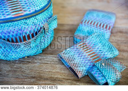 Blue Python Leather Product: Backpack, Wallet, Braslet On Wooden Background. Close Up.