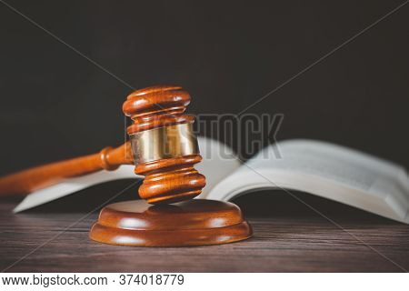 Old Wood Judge Hammer With Law Book On The Table Wood Background, Used For Adjudication And Justice.