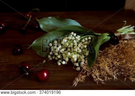 A Bouquet Of Lyses On A Wooden Table. With Copy Space.