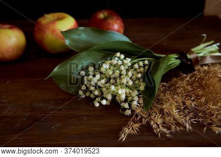 A Bouquet Of Lyses On A Wooden Table. With Copy Space.