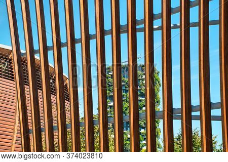 Milan, Italy, 06.29.2020: View Through A Wooden Fence Of The Vertical Forest (bosco Verticale) Innov