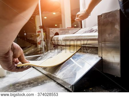 Chef Rolling Dough With A Pasta Machine. Pasta Maker Machine.