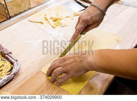 Chef Rolling Dough With A Pasta Machine. Pasta Maker Machine.