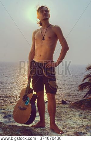Guitarman Stay With Guitar In Front Of The Sky With Rock