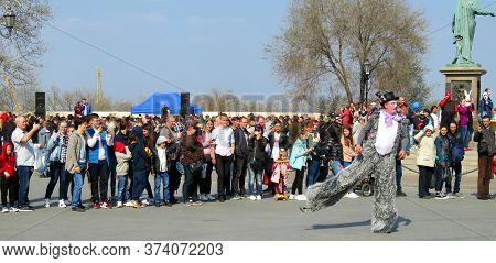 Odessa, Ukraine - 04 01 2019: Clown In A Cylindrical Black Hat And A Suit Covered In Gray Fur Perfor