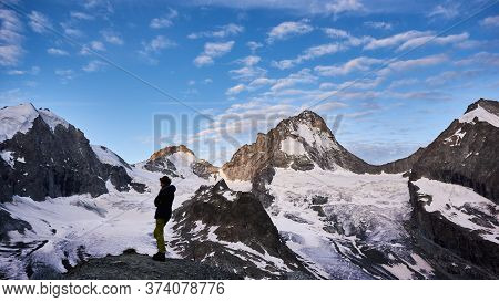 Zinal, Switzerland - July 19, 2019: Full Length Of Woman Hiker Admiring The Fantastic View Of Snow C