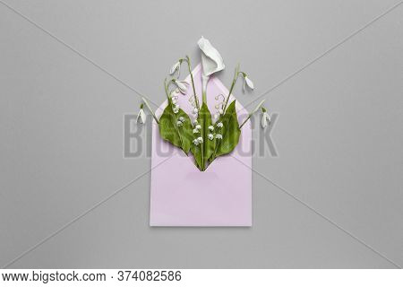 Spring Flowers In A Mail Envelope On A Gray Background. Romantic Birthday Greetings, Creative Weddin