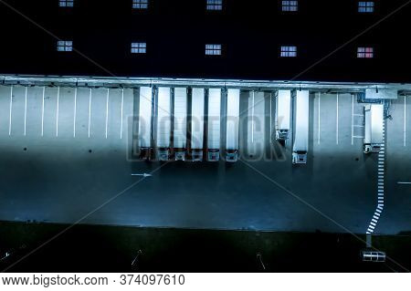 Night Loading Dock At A Warehouse. Modern Logistics Center. Docking Stations Of A Distribution Cente