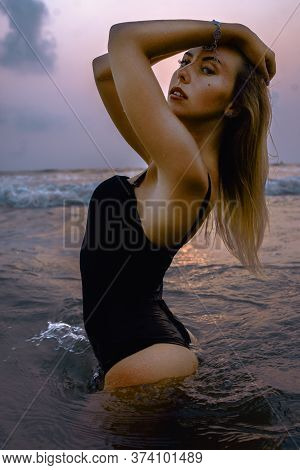 Girl Posing In Swimwear On The Beach In Water