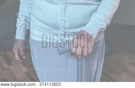 Old Wrinkled Hands On Walking Frame. Hands Of A Standing Senior Woman Leaning On A Rollator. Pension
