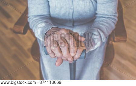 Old Wrinkled Hands On Walking Frame. Hands Of A Standing Senior Woman Leaning On A Rollator. Pension