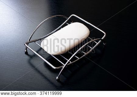 Soap In Metal Soapbox On Wooden Table