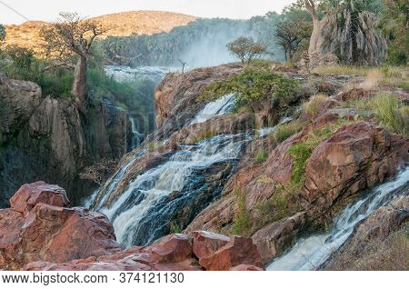 Part Of The Epupa Waterfalls In The Kunene River At Sunset. Baobab Trees Are Visible