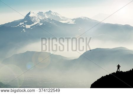Spectacular Mountain Ranges Silhouettes. Man Reaching Summit Enjoying Freedom. View From Top Of Moun