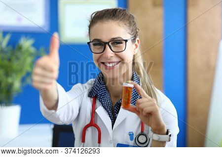 Portrait Of Smiling Woman Looking At Camera With Happiness And Calmness. Doctor Holding Pills In Tub