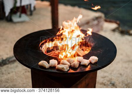 Fish Steaks Are Grilled. Close-up Of Pieces Of Fish. Round Grill Bowl, Round Roaster With A Fire In 