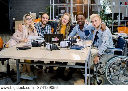 Inclusion In Work, Business Team Concept. Handsome Male Coworker On Wheelchair With His Creative Bus