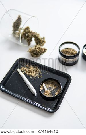 Indica Sativa Medical Health. White Background. Kief In Grinder Close Up Vertical Shot.