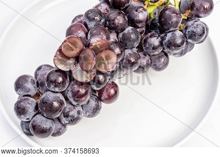 Kyoho Plump Kyoho Grapes (giant Mountain Grapes) Isolated On White In A Dripping Dish, Sweet And Del