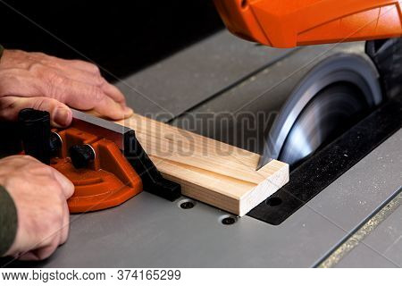 A Man Is Sawing Wood On A Circular Table Saw, Close Up
