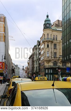 Prague, Czech Republic - November 2013: Bright Yellow Taxi Cabs On A City Street In Evening Prague