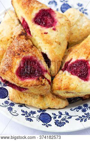 Skones With Raspberries For A Traditional British Afternoon Tea Party.