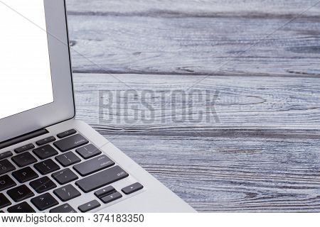 Open Laptop Computer On Wooden Table. Freee Space For Text.