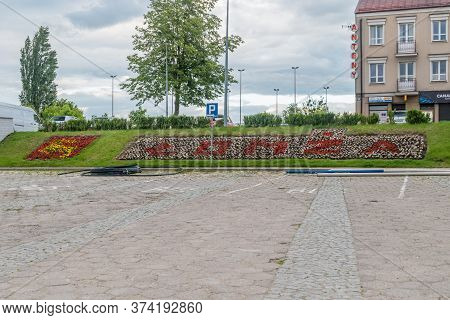Lomza, Poland - June 1, 2020: Independence Square With Sign And Coat Of Arms Of Lomza.