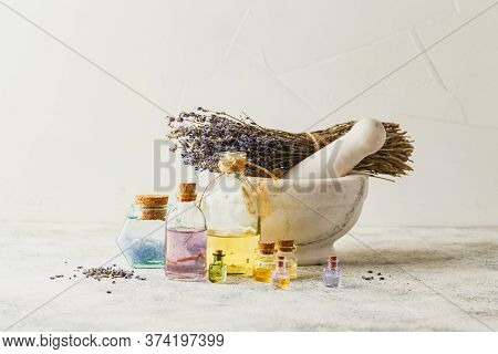 Aromatic Oils In Glass Bottles, Marble Mortar And Dry Lavender. Concept Natural Ogranic Skincare Cos