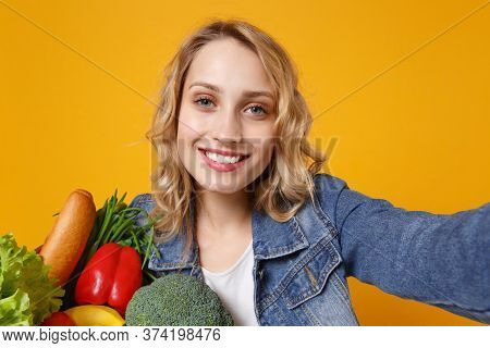 Close Up Of Young Woman In Denim Clothes Isolated On Orange Background. Delivery Service From Shop O