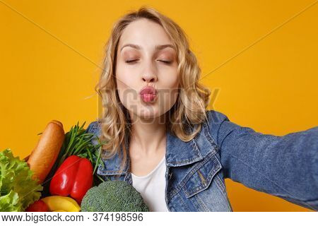 Close Up Of Young Woman In Denim Clothes Isolated On Orange Background. Delivery Service From Shop O