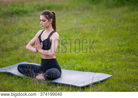Fitness And Lifestyle Concept - Woman Doing Yoga In Nature