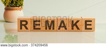 Remake Word Made On Wooden Cube Blocks And Flower In A Pot On Background. Health And Medicine Concep