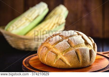 Small Homemade Bread, Biscuit Called Broa Or Broinha, Bread Made From Corn, On A Rustic Wooden Backg