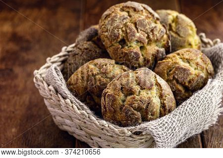 Small Homemade Bread, Biscuit Called Broa Or Broinha, Bread Made From Corn, On A Rustic Wooden Backg