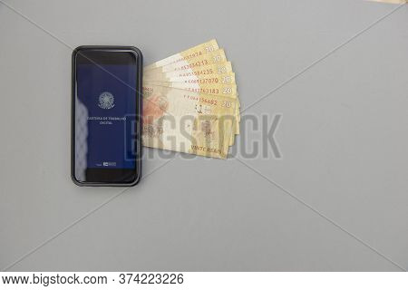 June 27, 2020, Brazil: Top View Of Cellphone And Real Banknotes - Brazilian Work Document And Social