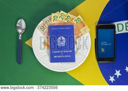 Florianopolis, Brazil. June 27, 2020: Money In Work Card And Cell Phone With The Image Of The Emerge