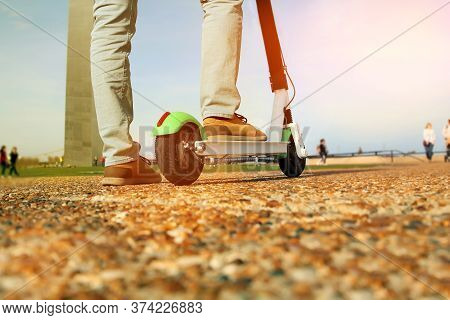 Close Up Image Of A Man On An Electric Scooter In The Street. Smart City