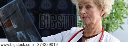 Experienced Doctor Woman Looking At Mri Picture. Radio Waves And Magnetic Field Are Read By Special 