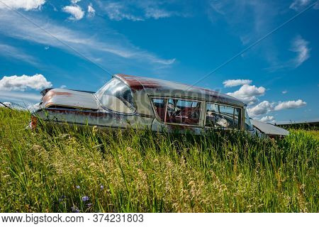 Wymark, Sk/canada- June 28, 2020:  Abandoned Vintage Nash Rambler Blue Sedan In The Tall Grass On A 
