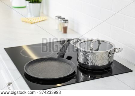 Pot And Frying Pan On Stove In Kitchen