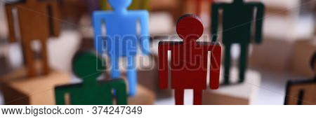 Colored Wooden Figures In Form Man Stand Table. Desire To Perform Tasks That Are Prescribed In Job D
