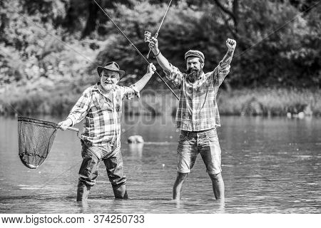 Fisherman With Fishing Rod. Activity And Hobby. Fishing Freshwater Lake Pond River. Bearded Men Catc